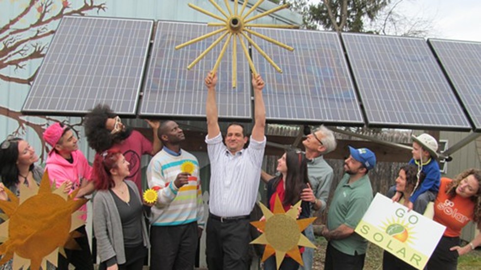 This photo of renewable energy enthusiasts was taken in front of the Forsyth Nature Center’s solar array in Kingston.