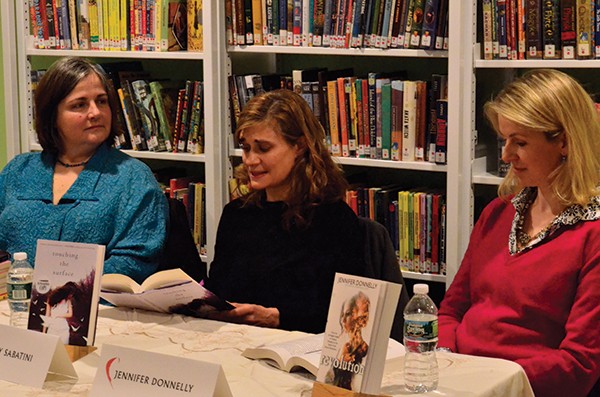 Authors Maya Gold and Jennifer Donnelly listen as Kimberly Sabatini reads from her book during the Hudson Valley YA (Young Adult) Society panel discussion at the 2nd Annual Read Local! Red Hook Literary Festival.