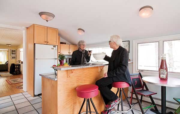 Barbara Pokras and Bob Malkin in their kitchen with some - Think Big! products: giant cup/saucer and ketchup bottle.
