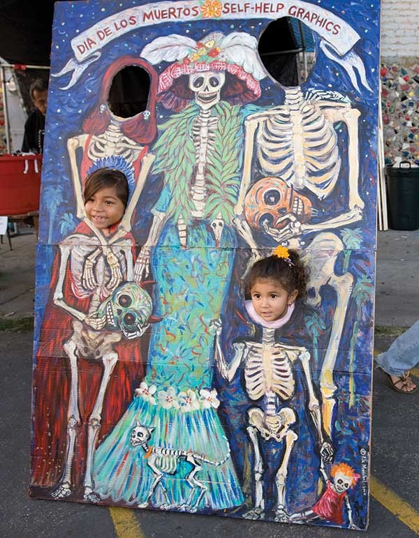 Children have their picture taken during a celebration of the Day of the Death or “Dia de los Muertos” in Los Angeles.