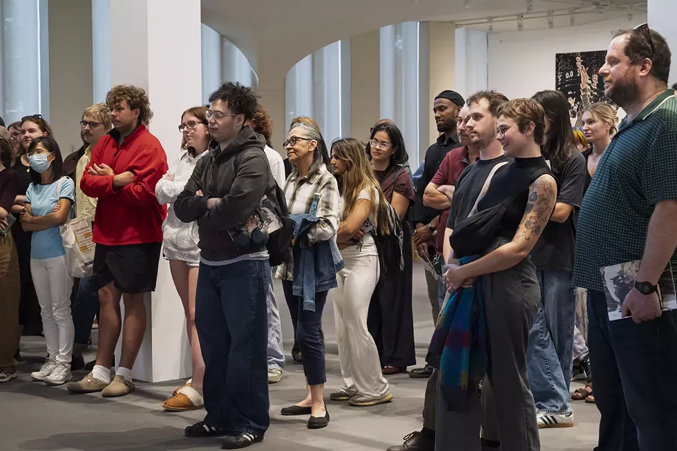 A crowd is gathered in the University Art Museum