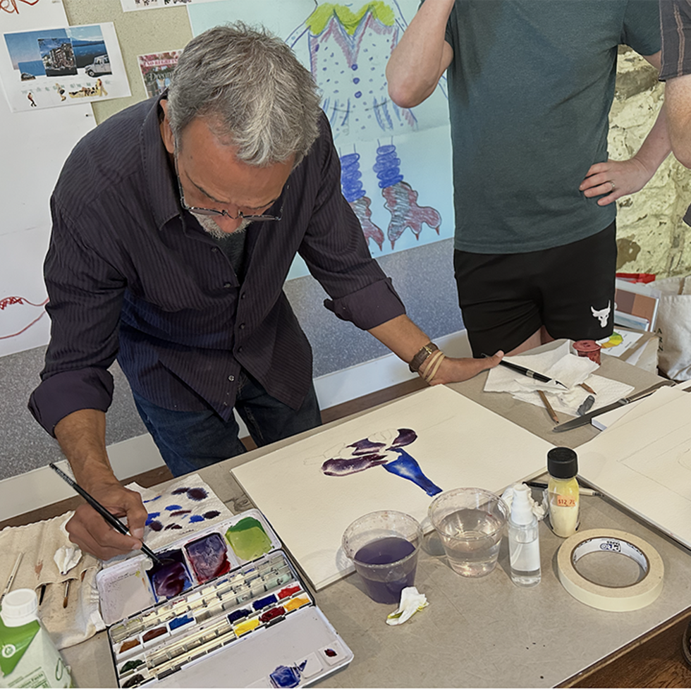 Male painting with watercolor on a table