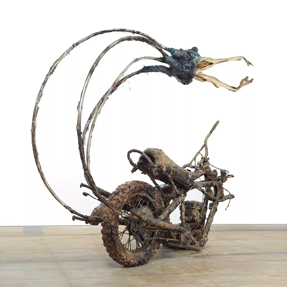 Daniel Giordano, My Scorpio I, 2016&ndash;19, 1970s Husqvarna motocross bikes, aluminum, Canadian maple syrup, cattails, ceramic, deep-fried batter, epoxy, phosphorescent acrylic paint, plastic wrap, railroad spikes, steel, stockfish, urinal cake, 88" x 72" x 24"