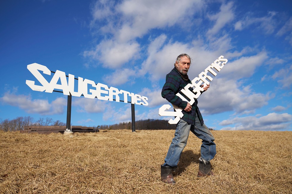 Artist Ze’ev Willy Neumann in front of his Saugerties sculpture/sign on Snyder Hill off Route 212. The stainless steel artwork was fabricated by Michael LoDolce of LoDolce Machine Co. and installed by John Mullen of J. Mullen and Sons.