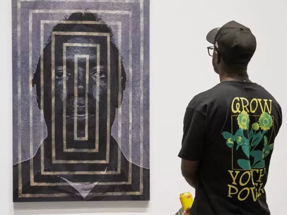 A visitor observes "Stella's Ground" (2022 - 23), a woven tapestry by Noel W Anderson in Noel W Anderson: Black Excellence