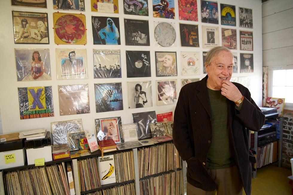 ARChive of Contemporary Music founder and director Bob George in front of his wall of signed records.