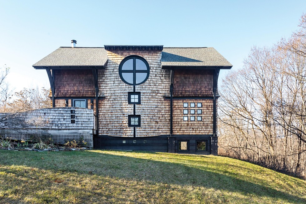 Designed by architect Donald E. Pulver, the home incorporates design elements symbolizing the Christian trinity. “The first owner and designer was a Christian mystic so there are many hidden religious elements integrated into the build,” says Jones. Along an exterior wall, square windows from the home’s two staircases combine with the second floor rose window to form a cross.