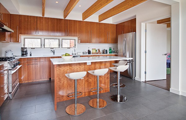 The modern kitchen is open to the dining area and great room, - but separated by the island with its eating area.