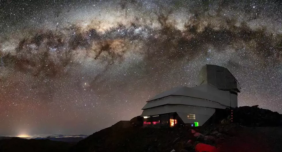 A photo of the Vera C. Rubin Observatory and its night-time sky.