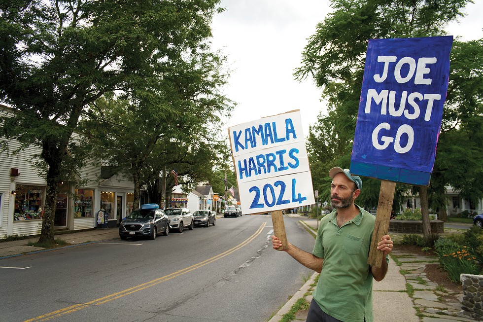 Woodstock resident Anthony Bonan on the Village Green on July 13. “I’ve never done anything like this before,” he says. “I woke up and thought I have to do something. My family helped me paint the sign.”