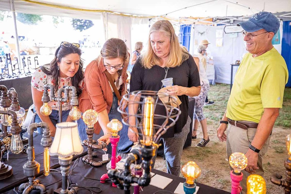 Shoppers at the booth of Mr. Willies Lighting.